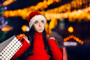 Woman with stressed look with holiday shopping bags